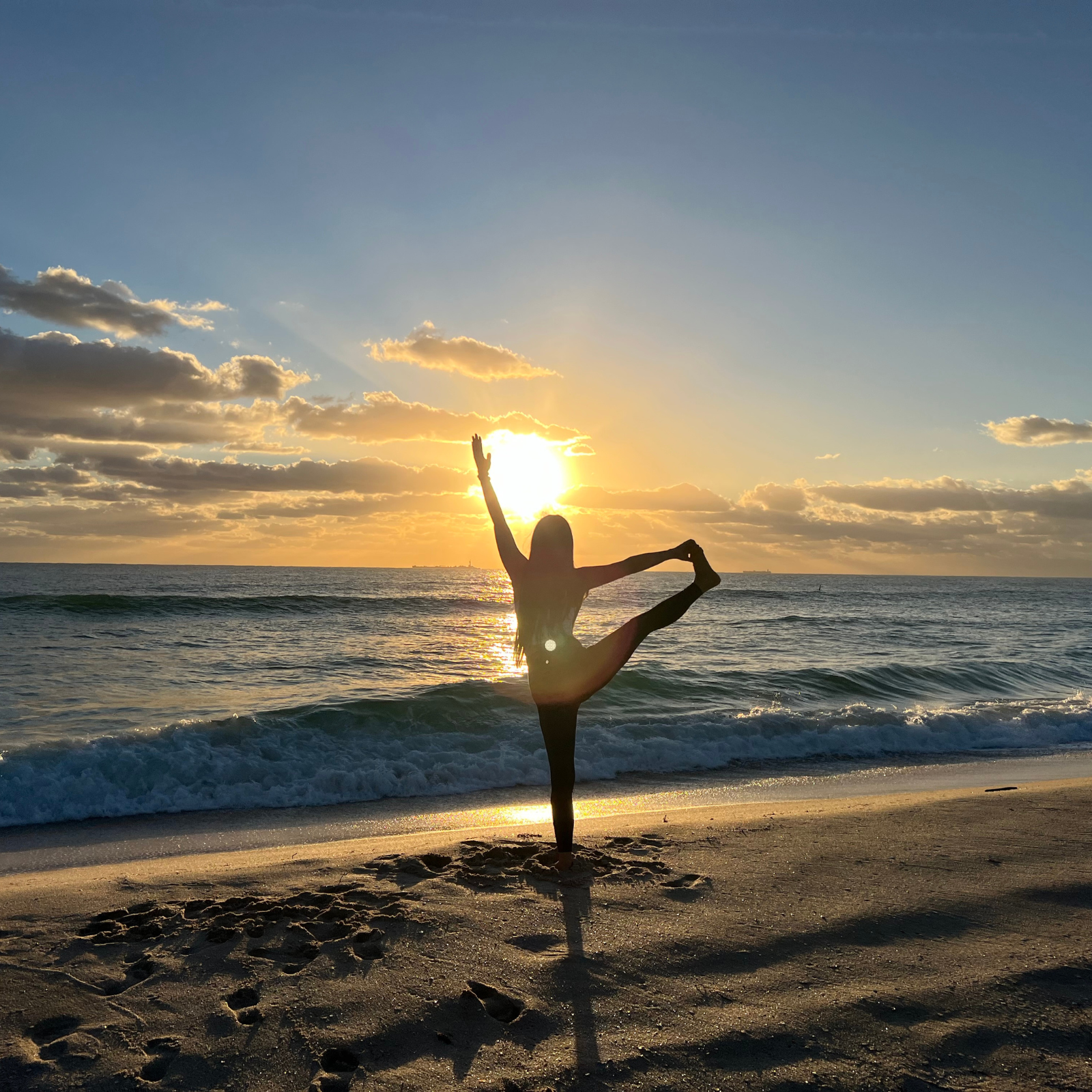 Lisa Yoga Angel doing a yoga pose on the beach at sunrise
