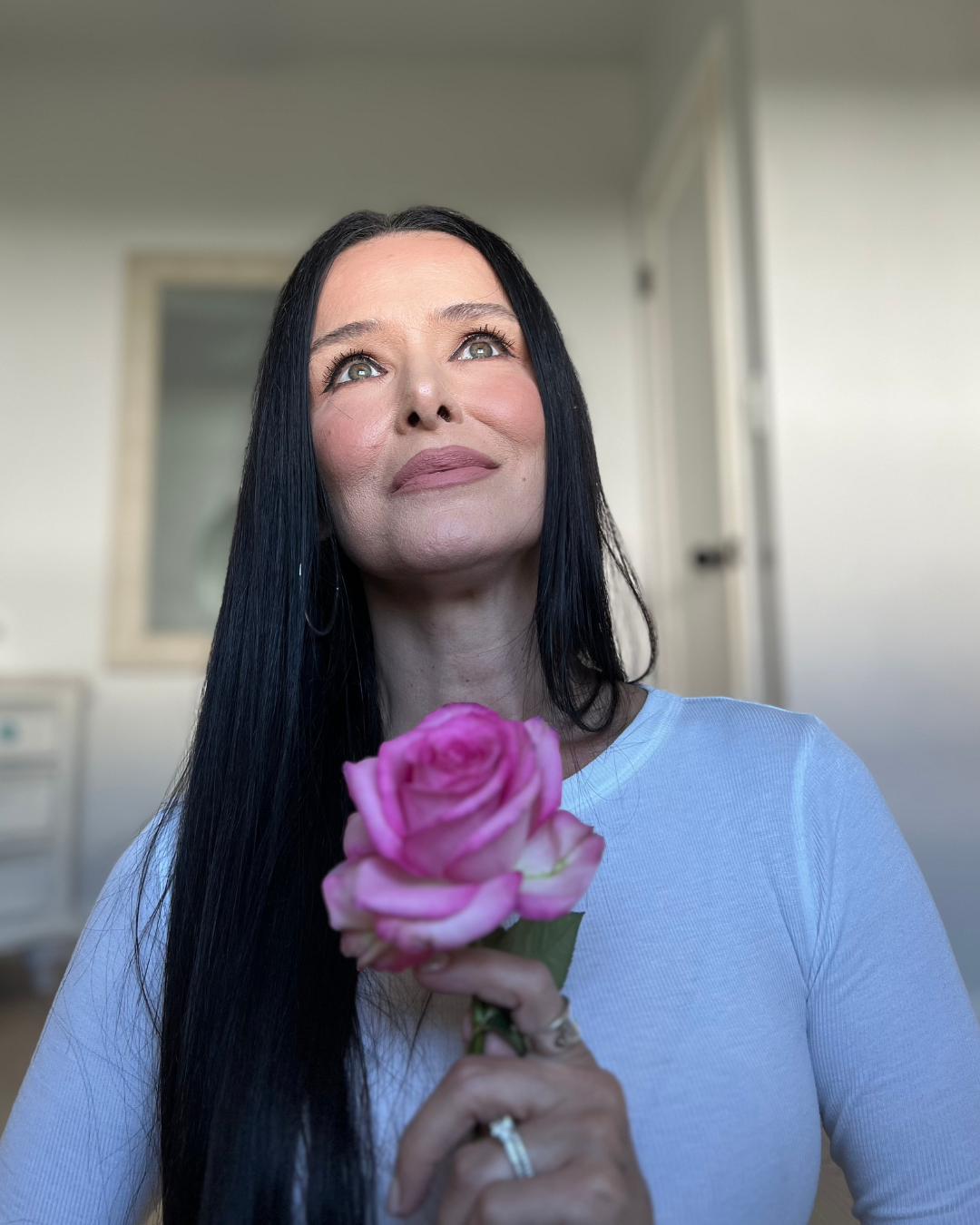 Lisa Yoga Angel holding a pink rose